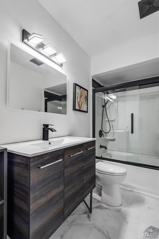 321 Fairview Ct, Ballwin, MO 63021 - bathroom featuring marble finish flooring, vanity, and shower / bath combination with glass door