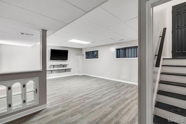 321 Fairview Ct, Ballwin, MO 63021 - finished basement with wood finished floors, stairs, and a paneled ceiling