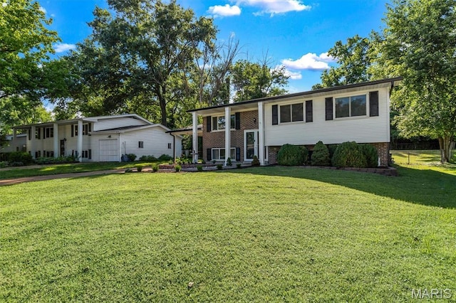321 Fairview Ct, Ballwin, MO 63021 - bi-level home featuring a front yard, brick siding, and a garage