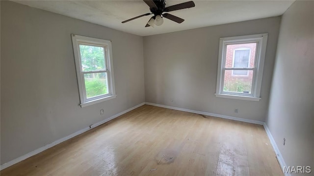 1938 Damato Ct, Jennings, MO 63136 - spare room featuring healthy amount of natural light, light wood-style floors, and a ceiling fan
