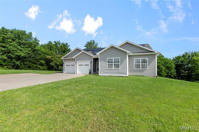 1638 County Road 642, Cape Girardeau, MO 63701 - view of front of home with roof mounted solar panels, driveway, an attached garage, and a front yard