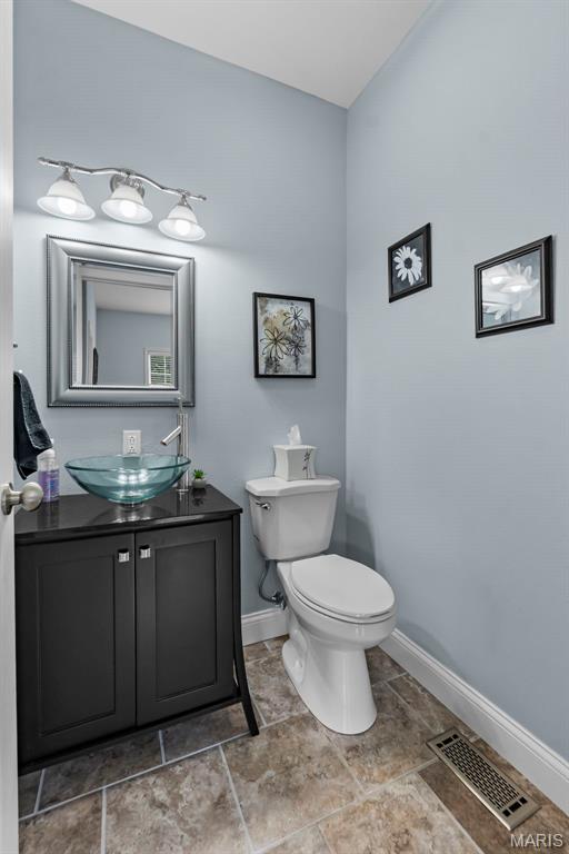 1638 County Road 642, Cape Girardeau, MO 63701 - half bathroom with baseboards, vanity, and toilet