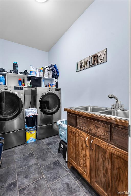 1638 County Road 642, Cape Girardeau, MO 63701 - washroom with cabinet space, separate washer and dryer, and dark tile patterned flooring