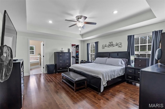 1638 County Road 642, Cape Girardeau, MO 63701 - bedroom featuring a raised ceiling, dark wood-style flooring, multiple windows, recessed lighting, and ensuite bath