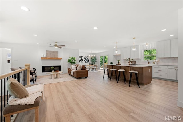 178 Spring Branch Rd, Troy, MO 63379 - living area featuring recessed lighting, a ceiling fan, light wood-type flooring, and a glass covered fireplace