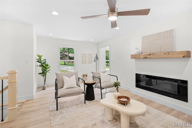 178 Spring Branch Rd, Troy, MO 63379 - living room with light wood-style floors, recessed lighting, a ceiling fan, and a glass covered fireplace