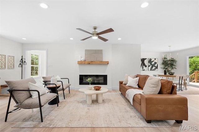 178 Spring Branch Rd, Troy, MO 63379 - living room with recessed lighting, light wood-style flooring, a ceiling fan, and a glass covered fireplace