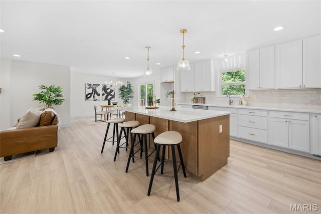178 Spring Branch Rd, Troy, MO 63379 - kitchen featuring a center island, light wood-style floors, white cabinetry, a breakfast bar, and recessed lighting