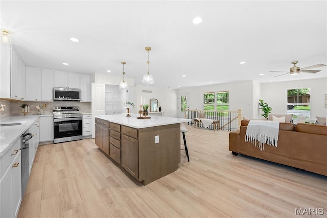 178 Spring Branch Rd, Troy, MO 63379 - kitchen featuring appliances with stainless steel finishes, recessed lighting, light wood-style floors, white cabinetry, and light countertops