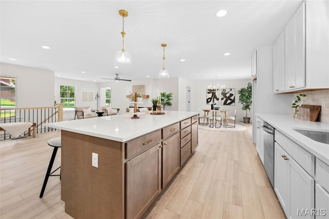 178 Spring Branch Rd, Troy, MO 63379 - kitchen featuring light wood-style floors, a center island, recessed lighting, a kitchen breakfast bar, and stainless steel dishwasher