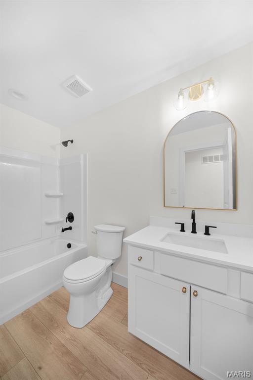 178 Spring Branch Rd, Troy, MO 63379 - bathroom with vanity, wood finished floors, and shower / bath combination