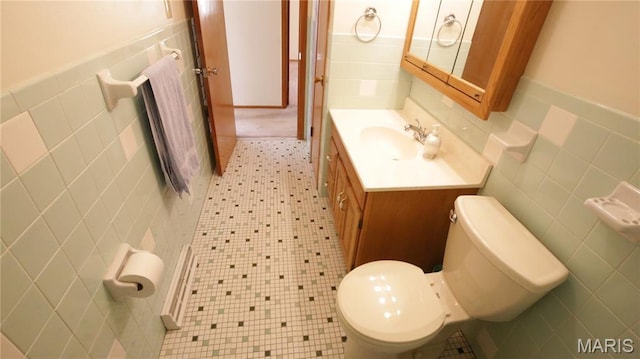517 N 11th, De Soto, MO 63020 - bathroom featuring tile walls, vanity, and a wainscoted wall