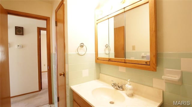 517 N 11th, De Soto, MO 63020 - bathroom with vanity, tasteful backsplash, and tile walls