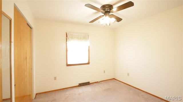 517 N 11th, De Soto, MO 63020 - unfurnished bedroom with a closet, light colored carpet, and ceiling fan