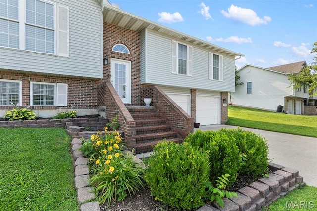 757 N W Ln, Jackson, MO 63755 - view of front of home with brick siding, concrete driveway, an attached garage, and a front yard