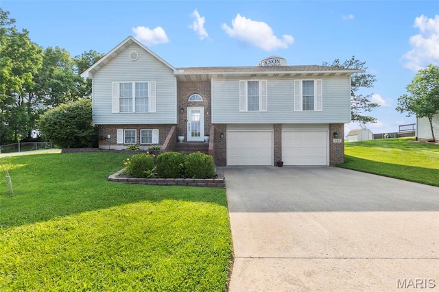 757 N W Ln, Jackson, MO 63755 - bi-level home featuring brick siding, driveway, a front yard, and a garage