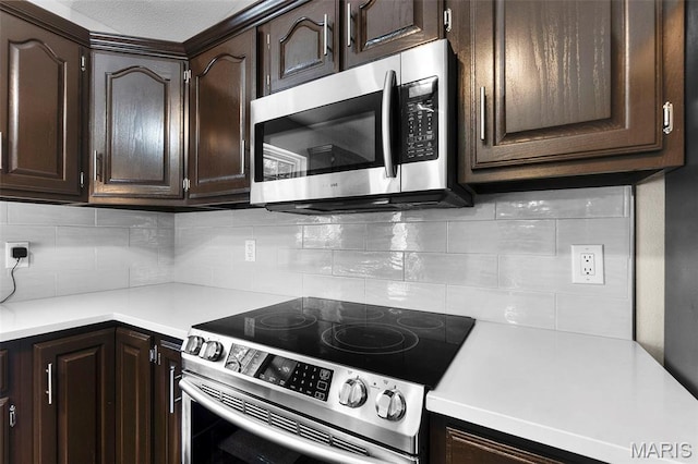757 N W Ln, Jackson, MO 63755 - kitchen featuring appliances with stainless steel finishes, dark brown cabinetry, decorative backsplash, and light countertops