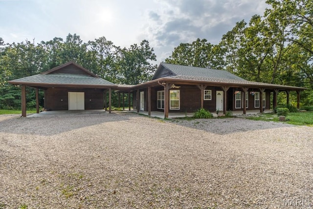 19395 Ripley Dr, Lebanon, MO 65536 - view of front of house with gravel driveway, an attached carport, and covered porch