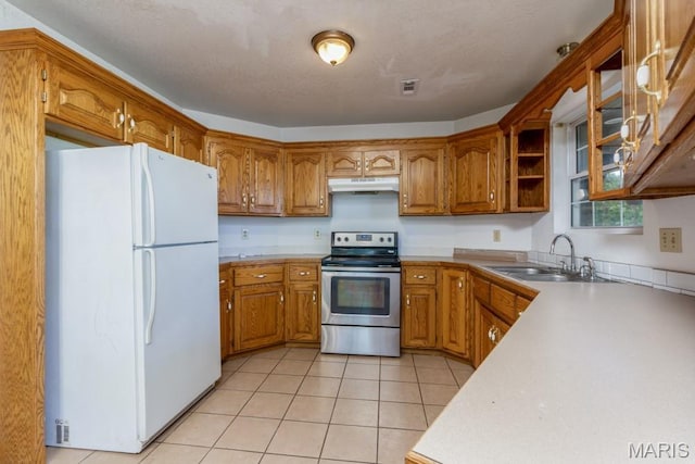 19395 Ripley Dr, Lebanon, MO 65536 - kitchen featuring freestanding refrigerator, stainless steel electric range, under cabinet range hood, brown cabinetry, and a sink