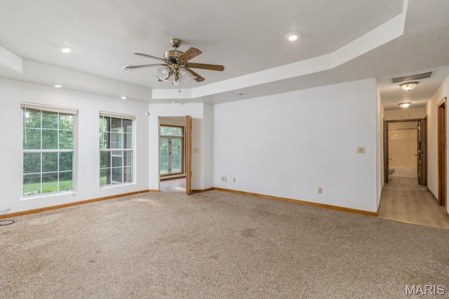 19395 Ripley Dr, Lebanon, MO 65536 - spare room with light carpet, a ceiling fan, baseboards, a raised ceiling, and recessed lighting