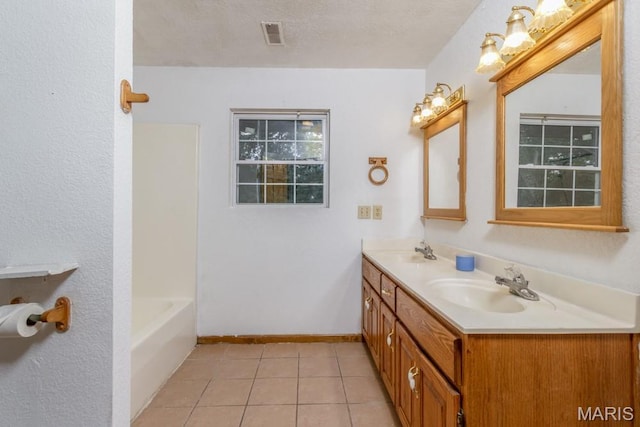 19395 Ripley Dr, Lebanon, MO 65536 - bathroom with double vanity, tile patterned flooring, baseboards, a textured ceiling, and bathtub / shower combination