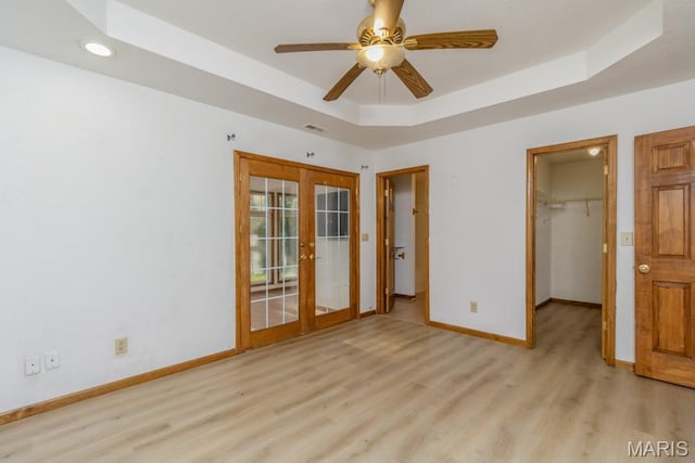 19395 Ripley Dr, Lebanon, MO 65536 - unfurnished bedroom featuring french doors, light wood-type flooring, baseboards, a tray ceiling, and recessed lighting