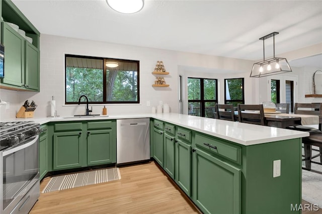 62 Majestic Ct, Fenton, MO 63026 - kitchen featuring stainless steel appliances, green cabinetry, a peninsula, and light countertops