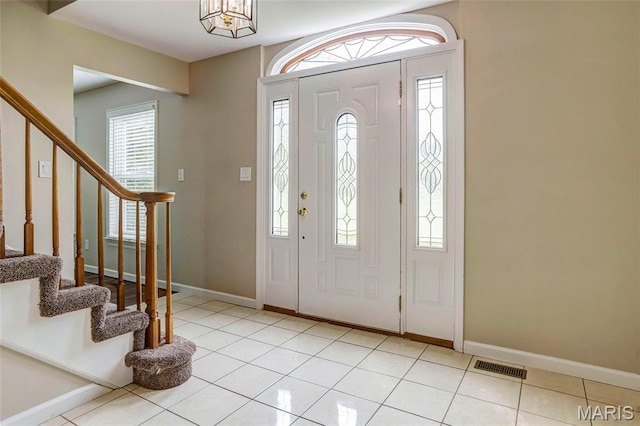 17560 Old Jamestown Rd, Florissant, MO 63034 - foyer entrance featuring stairway, light tile patterned floors, and baseboards