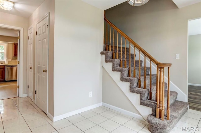 17560 Old Jamestown Rd, Florissant, MO 63034 - staircase with baseboards and tile patterned floors