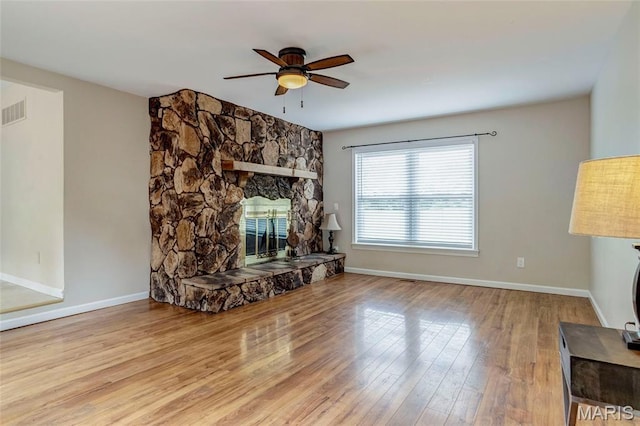 17560 Old Jamestown Rd, Florissant, MO 63034 - unfurnished living room with a ceiling fan, wood finished floors, a fireplace, and baseboards