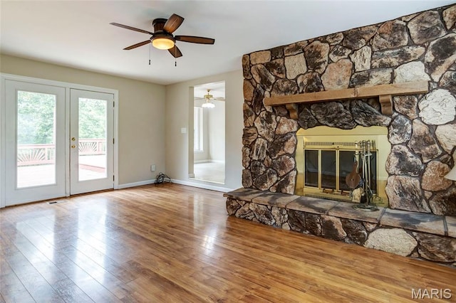 17560 Old Jamestown Rd, Florissant, MO 63034 - unfurnished living room with french doors, hardwood / wood-style floors, ceiling fan, and baseboards