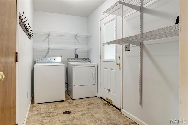 17560 Old Jamestown Rd, Florissant, MO 63034 - laundry area with washing machine and dryer and baseboards