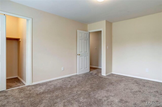 17560 Old Jamestown Rd, Florissant, MO 63034 - unfurnished bedroom featuring carpet flooring, baseboards, a closet, and a walk in closet