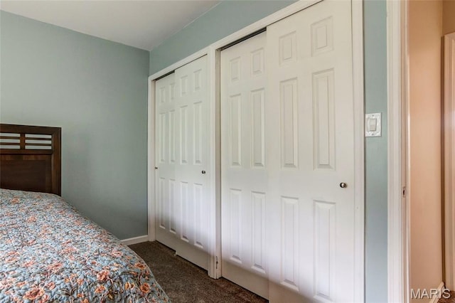 17560 Old Jamestown Rd, Florissant, MO 63034 - bedroom with dark colored carpet, two closets, and baseboards