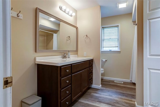 17560 Old Jamestown Rd, Florissant, MO 63034 - full bath featuring vanity, wood finished floors, toilet, baseboards, and curtained shower