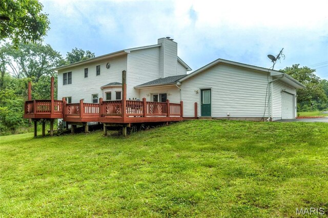 17560 Old Jamestown Rd, Florissant, MO 63034 - rear view of house with a deck, a lawn, an attached garage, and a chimney