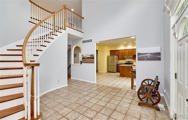 4 Hahn Estates Rd, Winfield, MO 63389 - foyer entrance featuring a high ceiling, arched walkways, and stairs