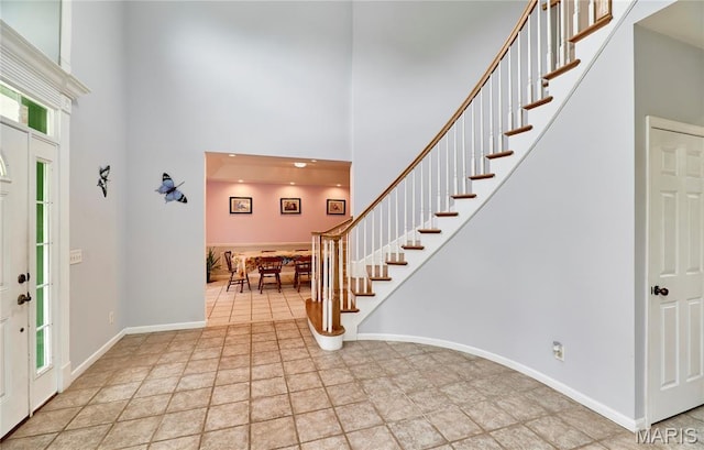 4 Hahn Estates Rd, Winfield, MO 63389 - entryway featuring a high ceiling, stairs, and light stone finish floors