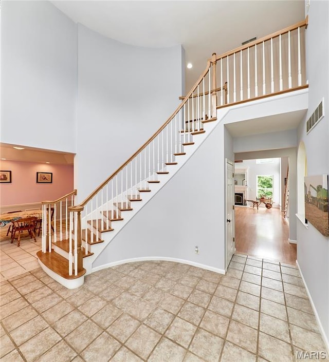4 Hahn Estates Rd, Winfield, MO 63389 - staircase featuring a towering ceiling and a fireplace