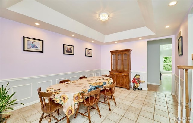 4 Hahn Estates Rd, Winfield, MO 63389 - dining area featuring light tile patterned floors, recessed lighting, a raised ceiling, a wainscoted wall, and a decorative wall