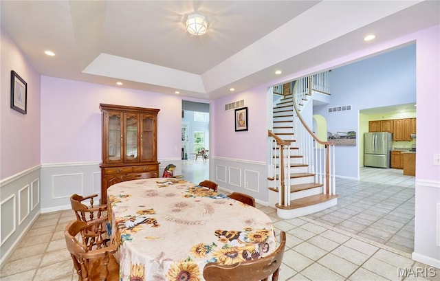 4 Hahn Estates Rd, Winfield, MO 63389 - dining room with light tile patterned floors, stairs, recessed lighting, a decorative wall, and a wainscoted wall