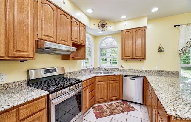 4 Hahn Estates Rd, Winfield, MO 63389 - kitchen with stainless steel appliances, under cabinet range hood, light tile patterned floors, recessed lighting, and light stone counters