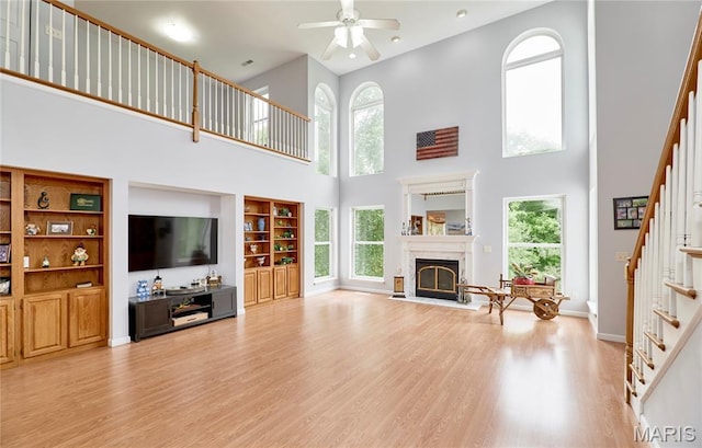 4 Hahn Estates Rd, Winfield, MO 63389 - living area featuring stairs, a high ceiling, light wood finished floors, plenty of natural light, and recessed lighting
