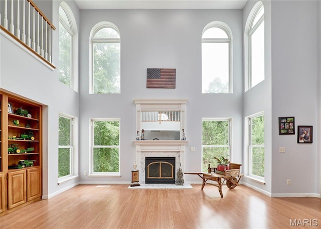 4 Hahn Estates Rd, Winfield, MO 63389 - living room with a towering ceiling, wood finished floors, and a fireplace with flush hearth
