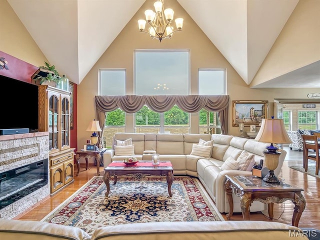 4184 Red Field Dr, Swansea, IL 62226 - living area featuring high vaulted ceiling, a chandelier, and light wood-type flooring