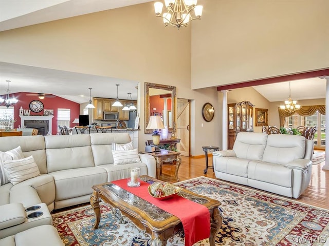4184 Red Field Dr, Swansea, IL 62226 - living room with a chandelier, light wood-style flooring, and high vaulted ceiling