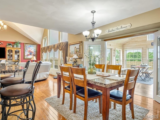 4184 Red Field Dr, Swansea, IL 62226 - dining space featuring vaulted ceiling, a chandelier, and light wood-style flooring