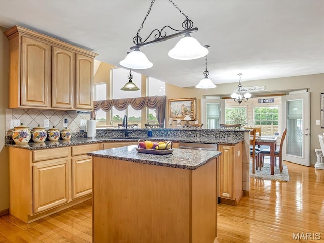 4184 Red Field Dr, Swansea, IL 62226 - kitchen featuring a kitchen island, light wood-style floors, backsplash, dark stone countertops, and a peninsula
