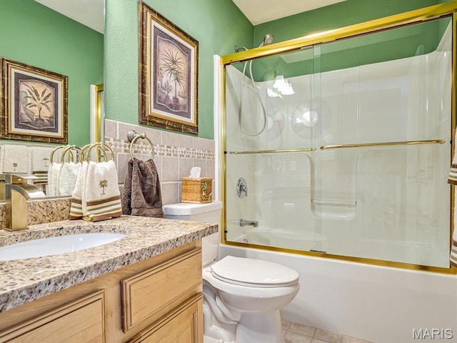4184 Red Field Dr, Swansea, IL 62226 - bathroom with vanity, tile patterned flooring, bath / shower combo with glass door, tile walls, and a wainscoted wall