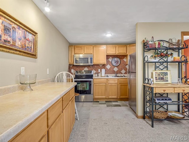 4184 Red Field Dr, Swansea, IL 62226 - kitchen featuring appliances with stainless steel finishes, light countertops, decorative backsplash, light tile patterned flooring, and light brown cabinets